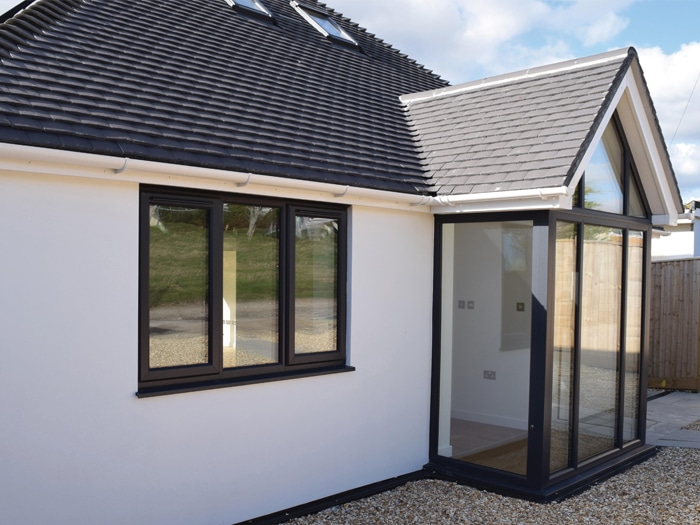 modern windows with black frames on white bungalow